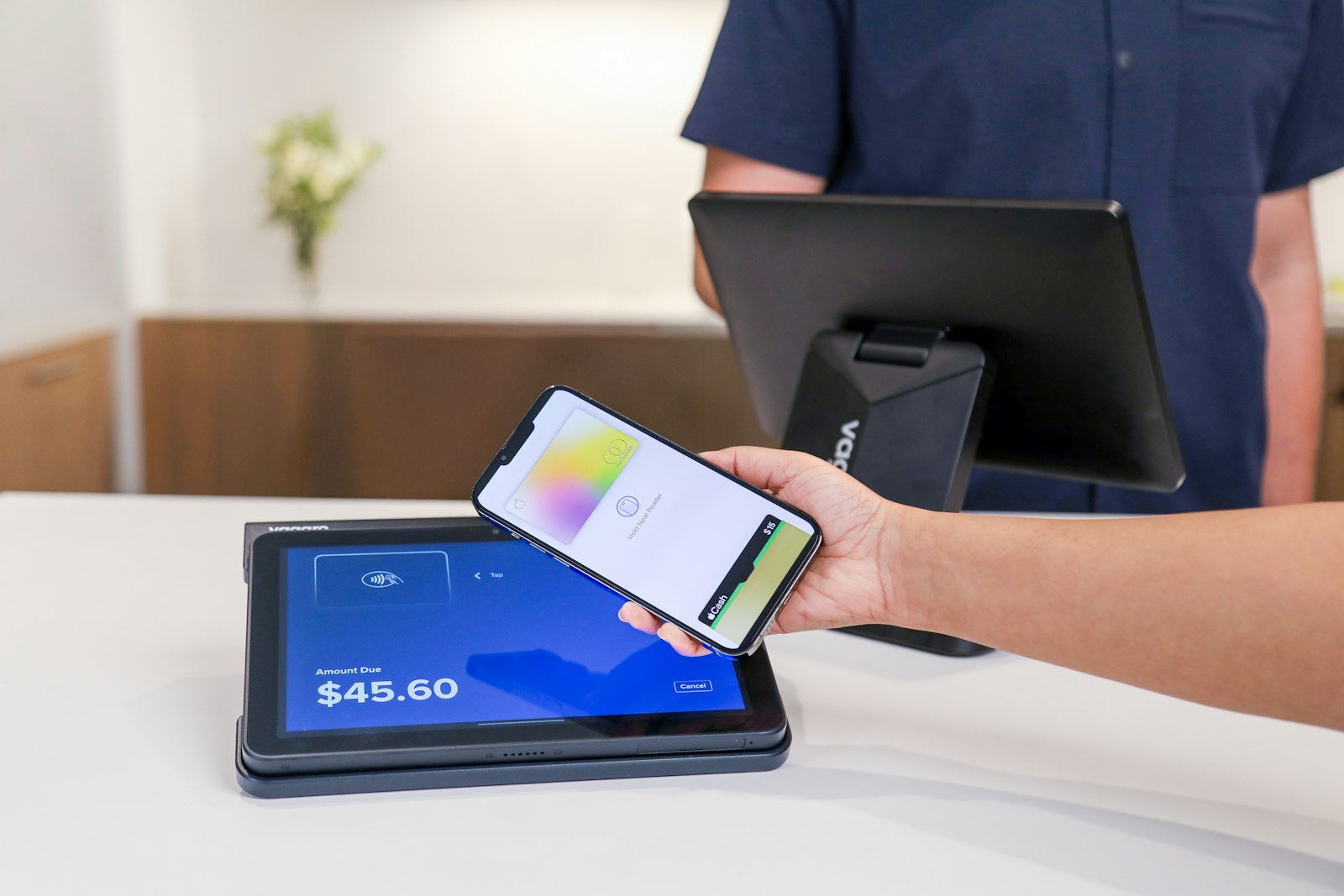 Customer paying with a smartphone at a checkout terminal